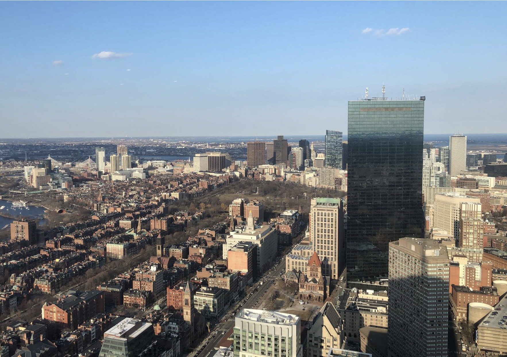  View of Boston from the Prudential Tower. The sky is clear and the John Hancock tower is in the frame.